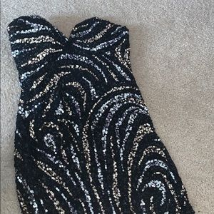 A flirty black dress with sliver and gold detail